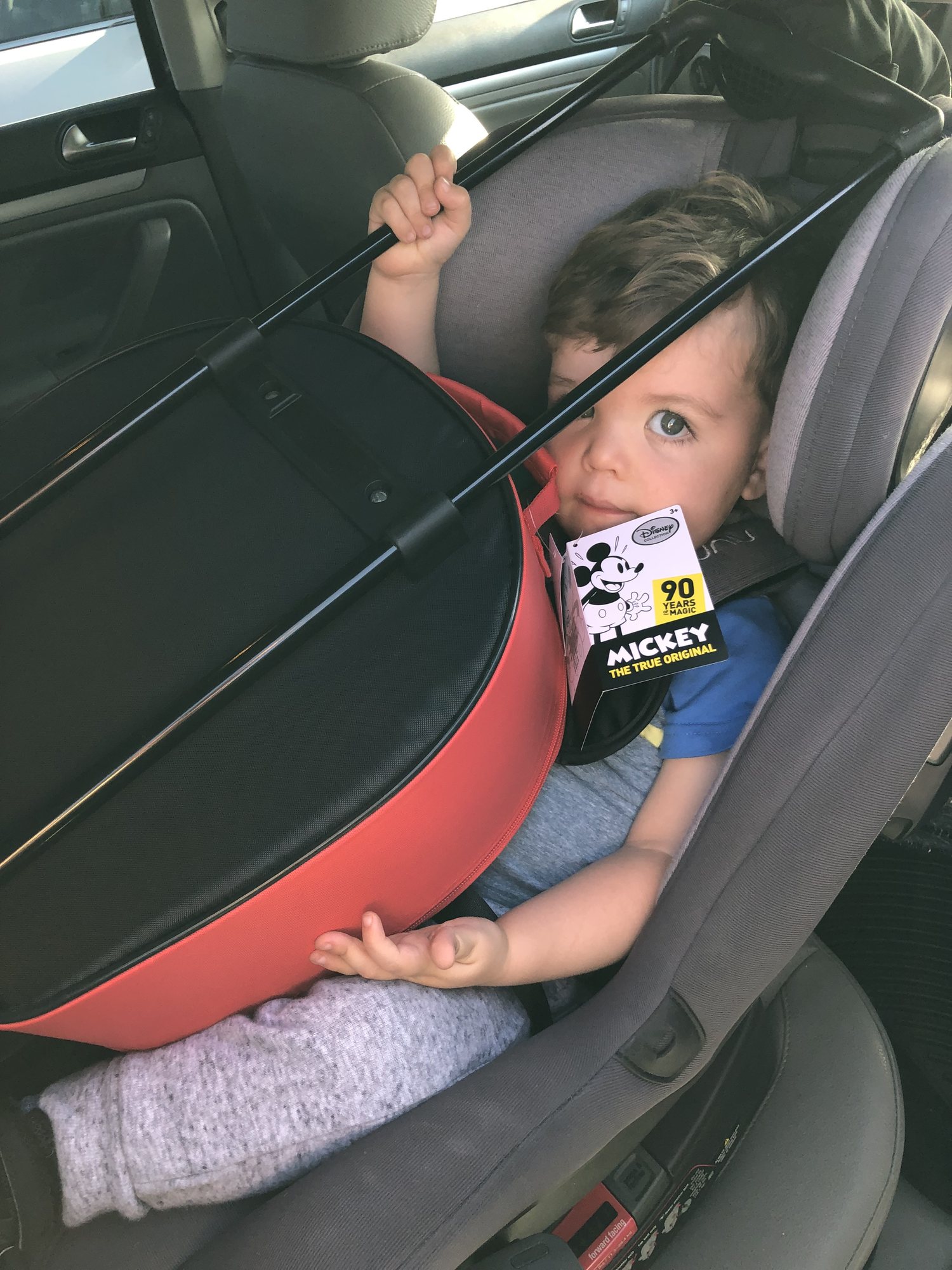 He loved his Mickey Mouse suitcase so much that he wanted to ride home with it.