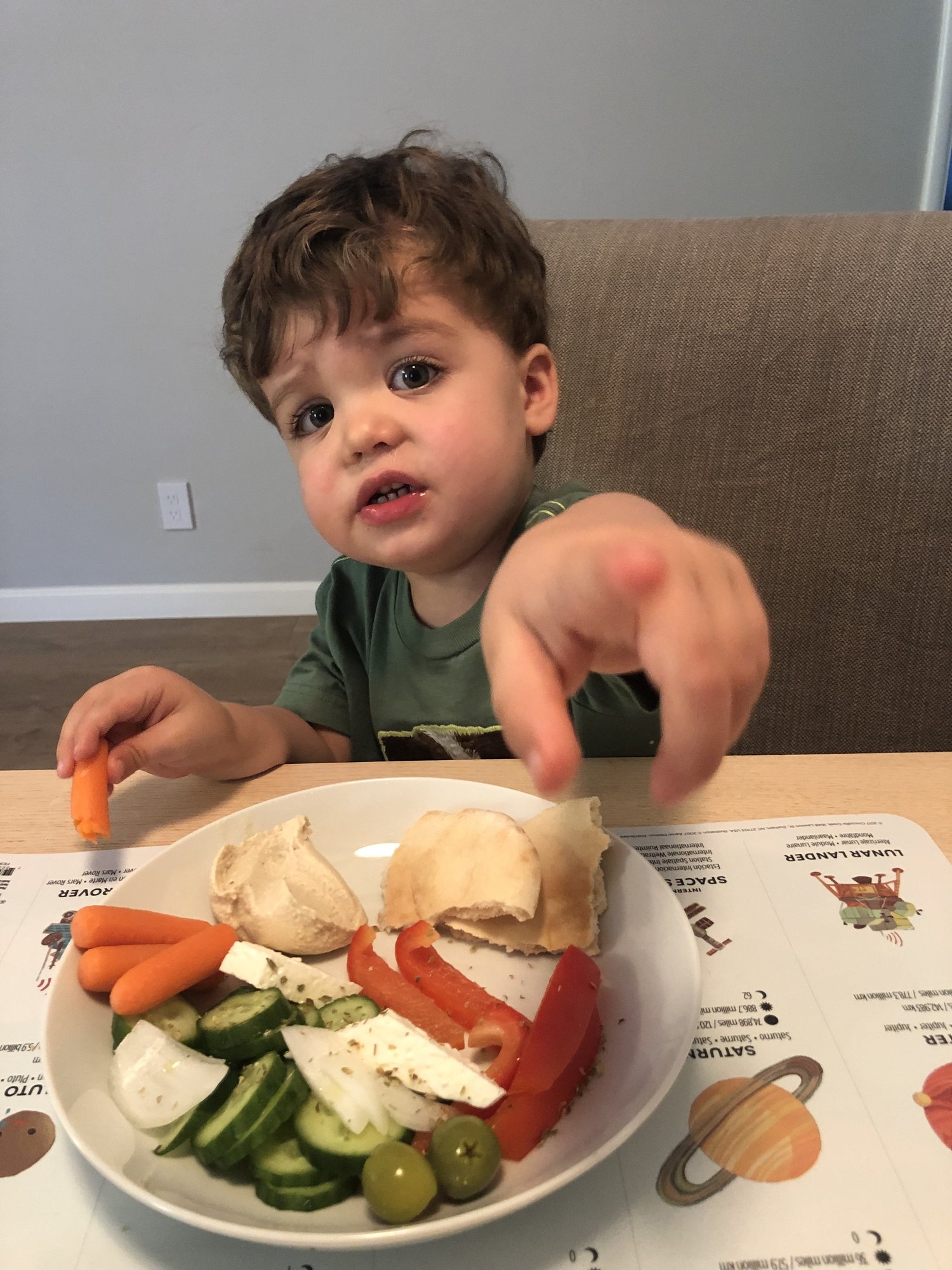 Ben eating a greek salad and telling me he doesn't want his picture taken.