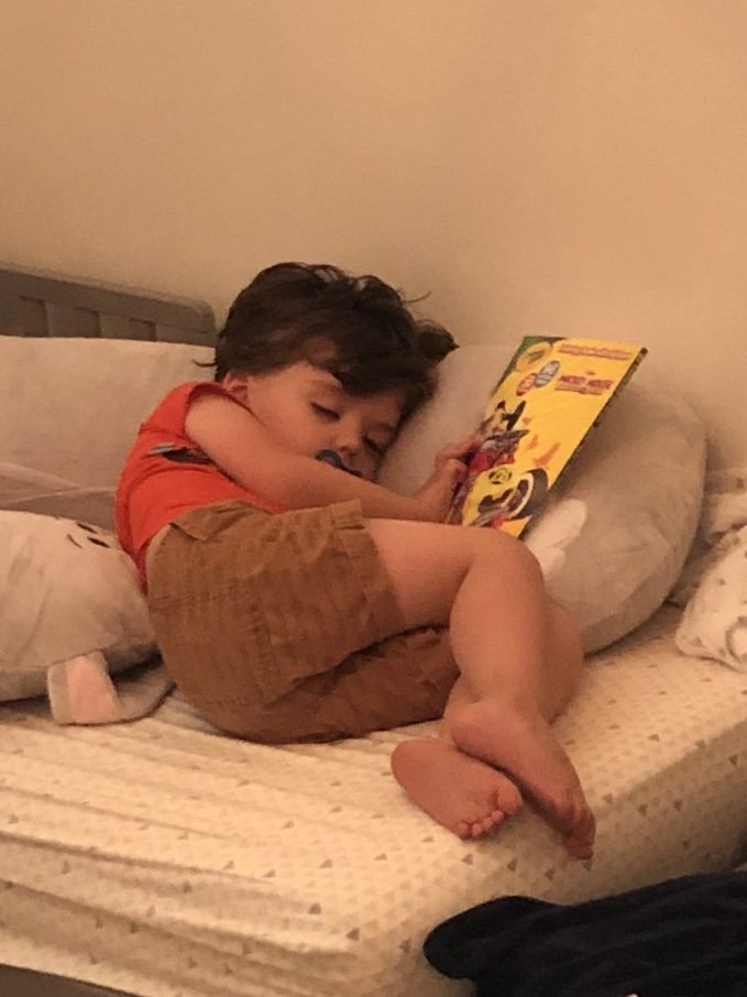 Curling up with his favorite book.