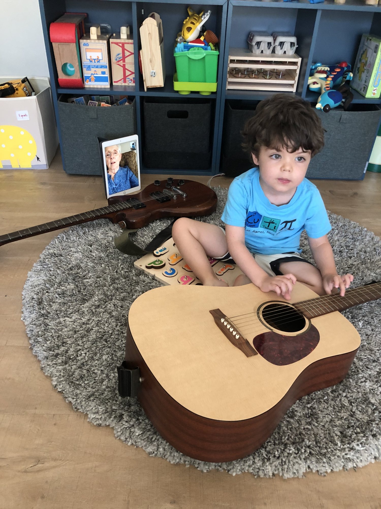 Ben plays guitar with Mema via FaceTime.