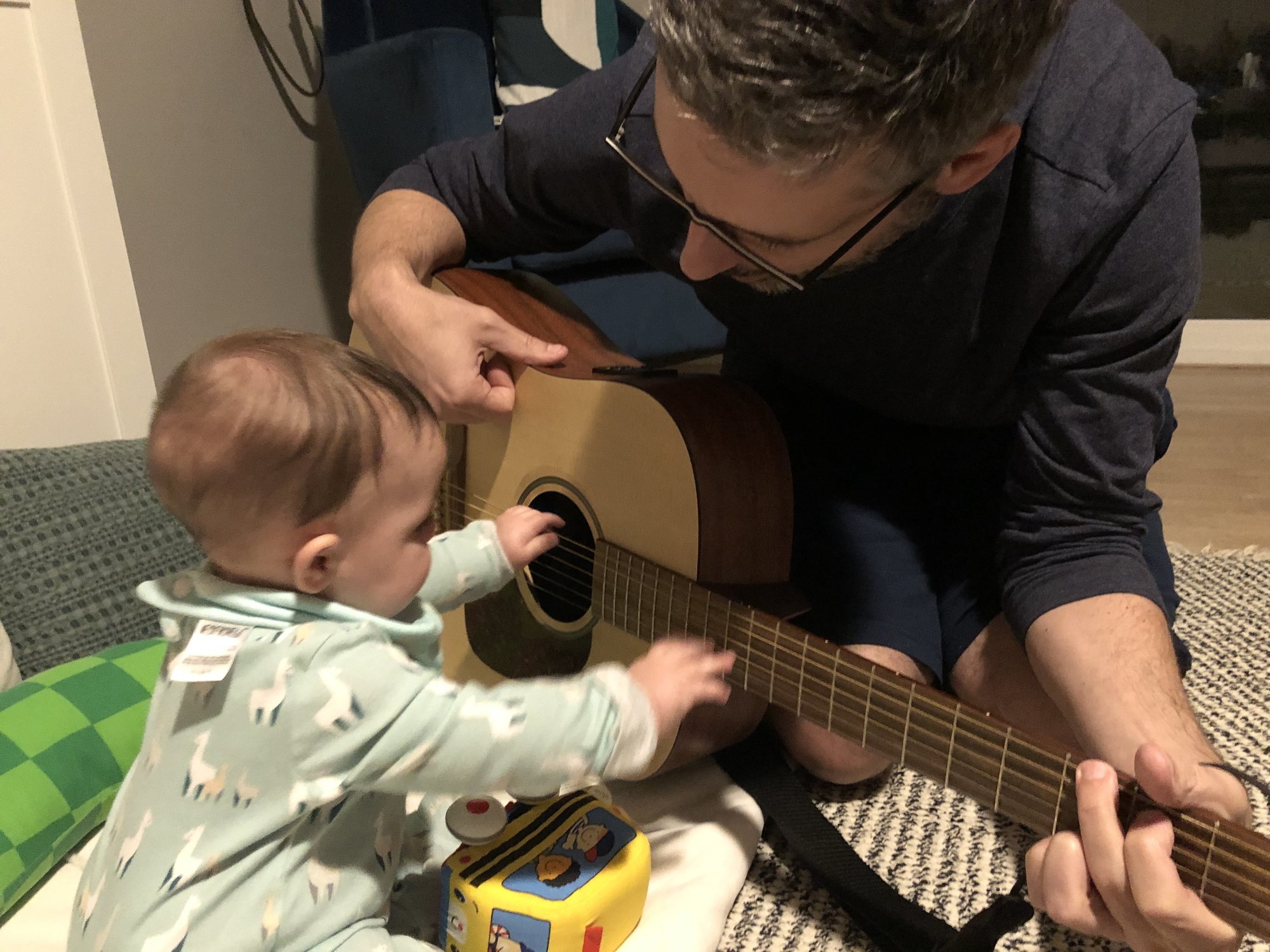 Nora loves watching dad play the guitar :)