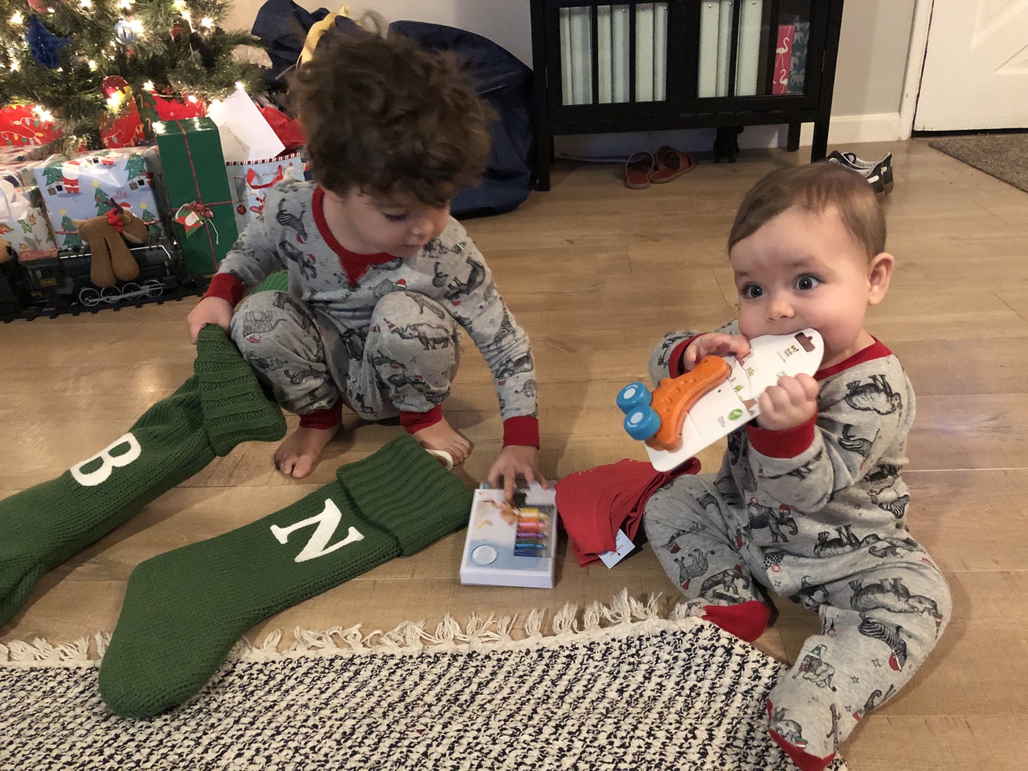 Christmas morning. Nori taste-tested all of her presents and Ben had to give all of Nora's presents a practice run.