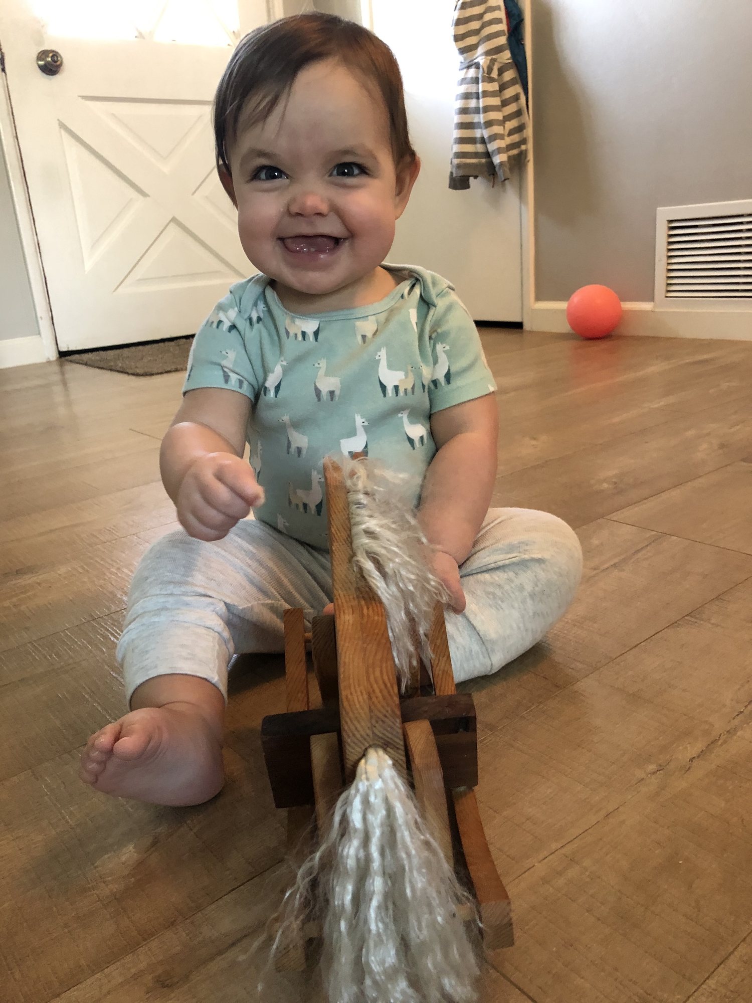 Playing with a horse made by her great-great grandfather!