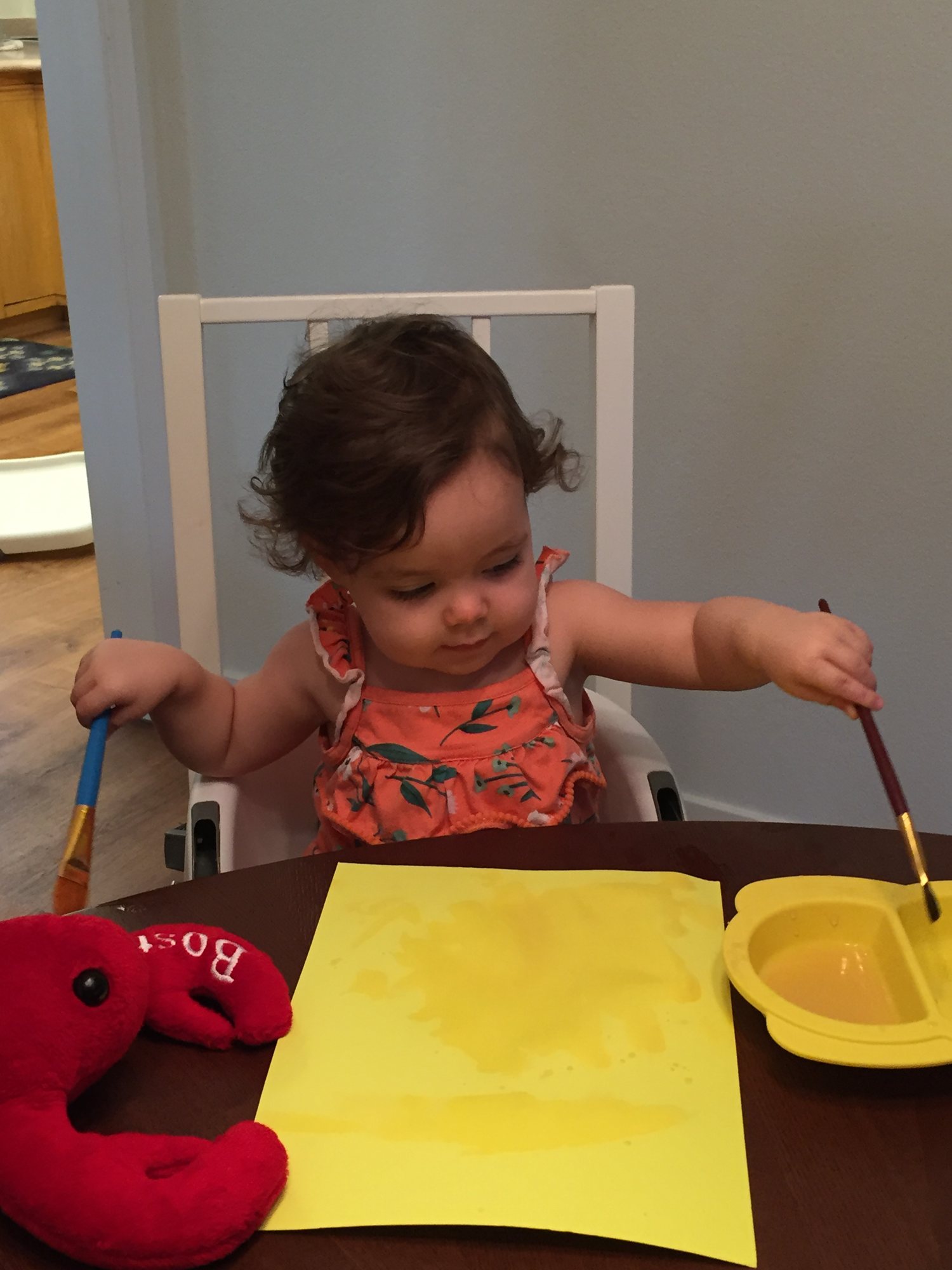 Nora painting. She prefers to use both hands :).