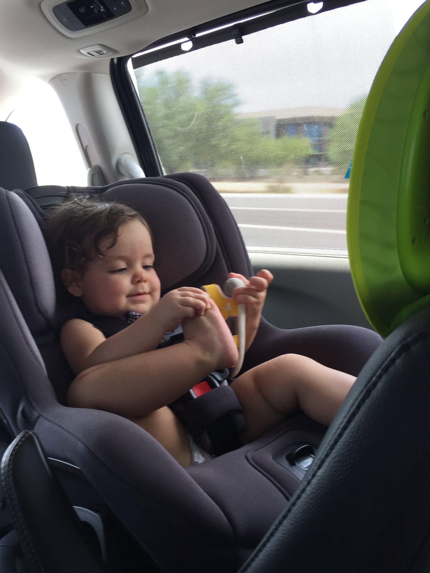 Trying hard to put her own shoe on!