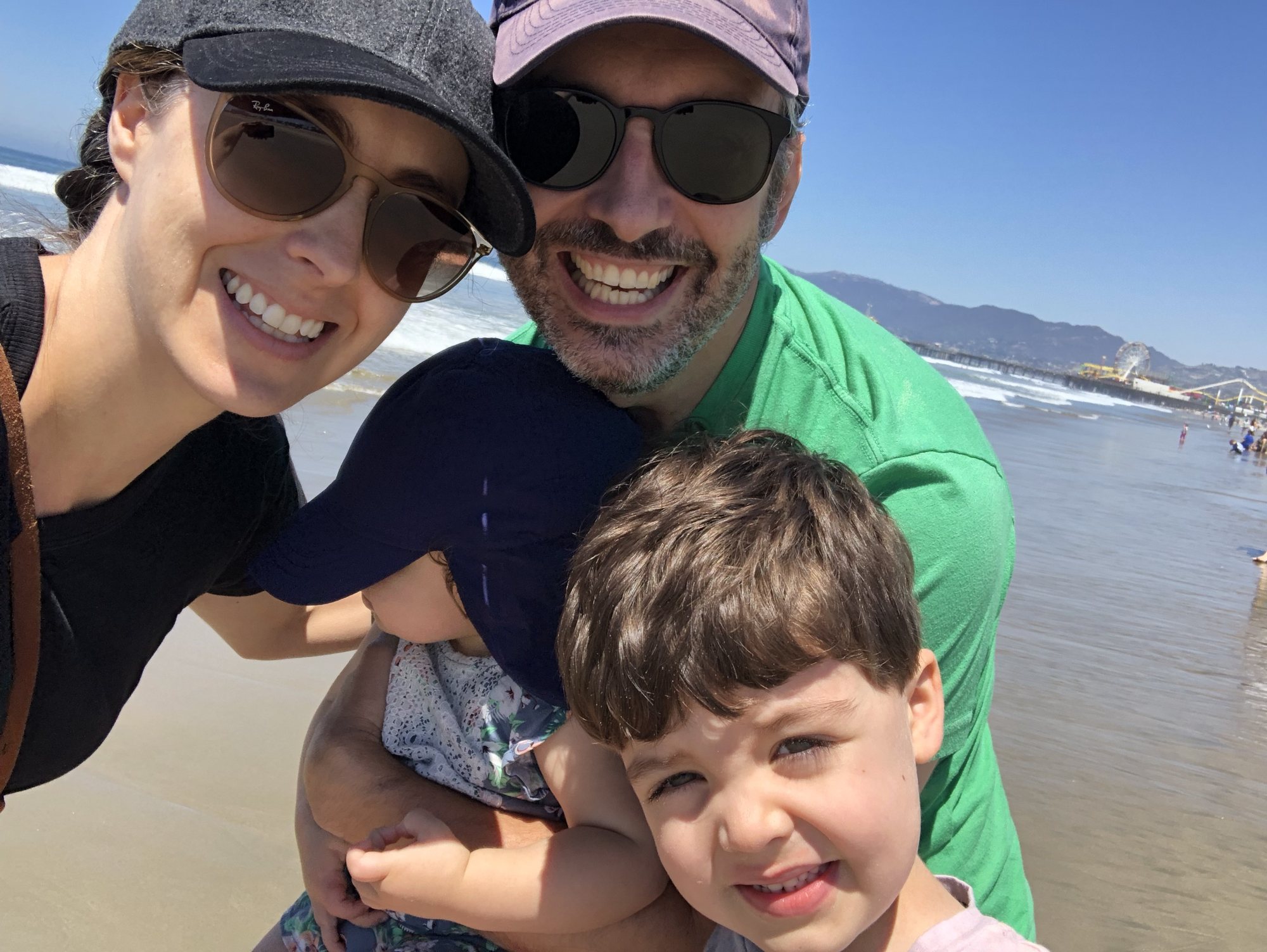 Cheesy family picture at the beach. Nora's in there, just hiding behind her hat :)