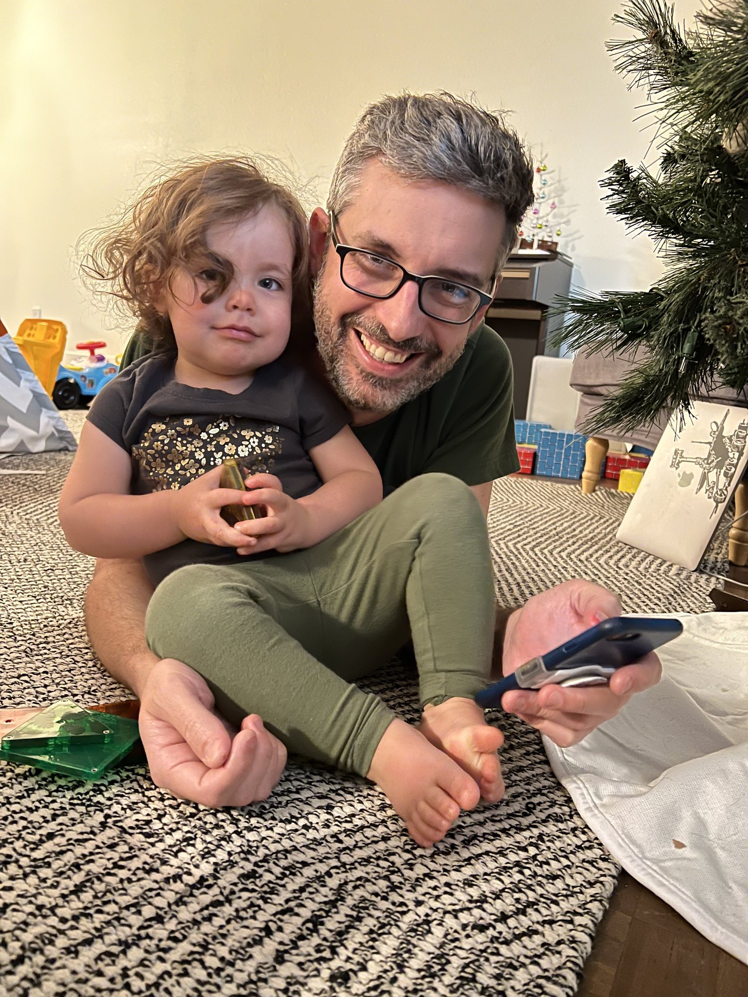 Cuddles with dad. Yes, our tree was still up.