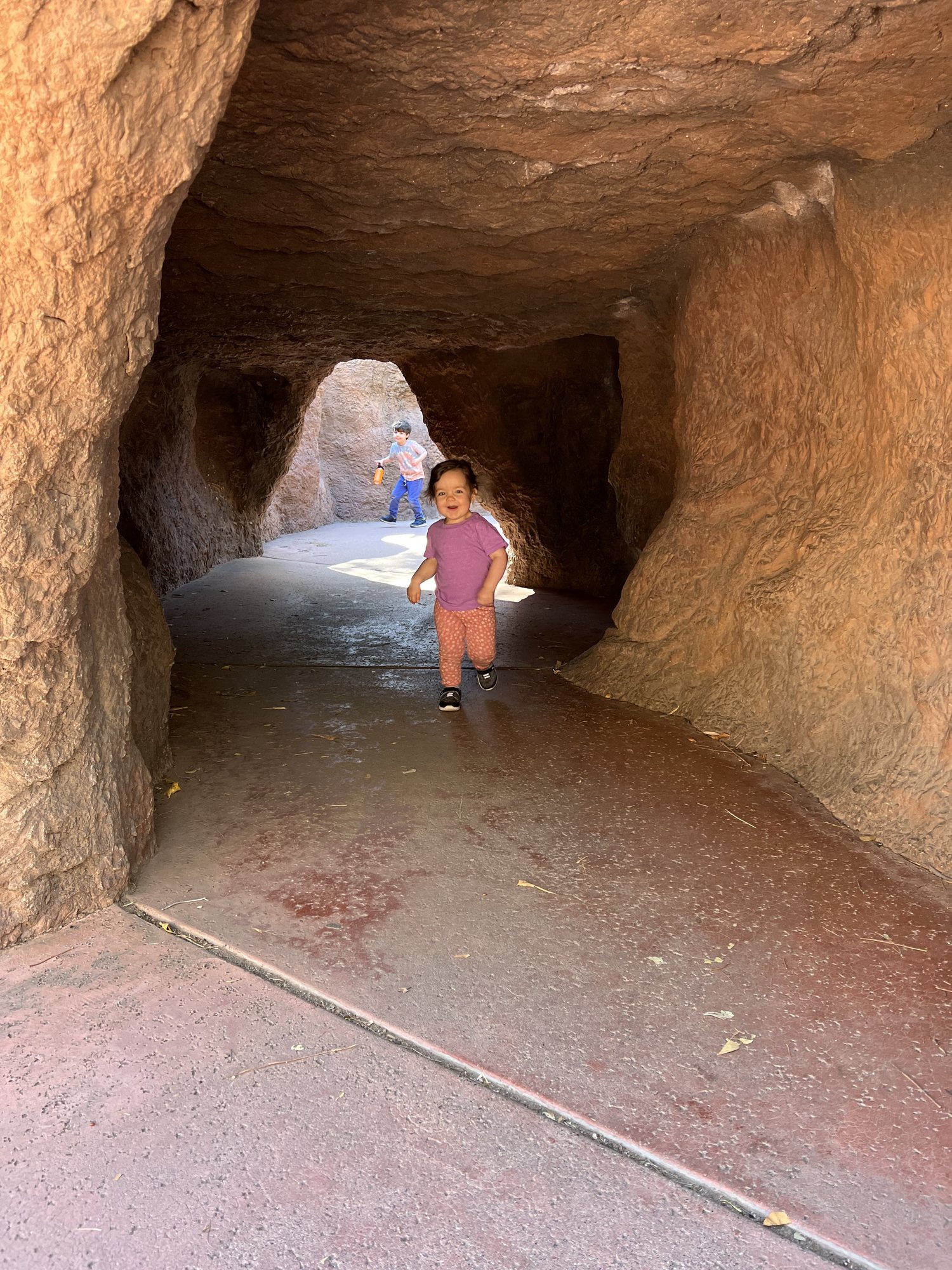 Running through a cave at the Phoenix Zoo. We were waiting for dad, who had to drive home to see why our alarm triggered!