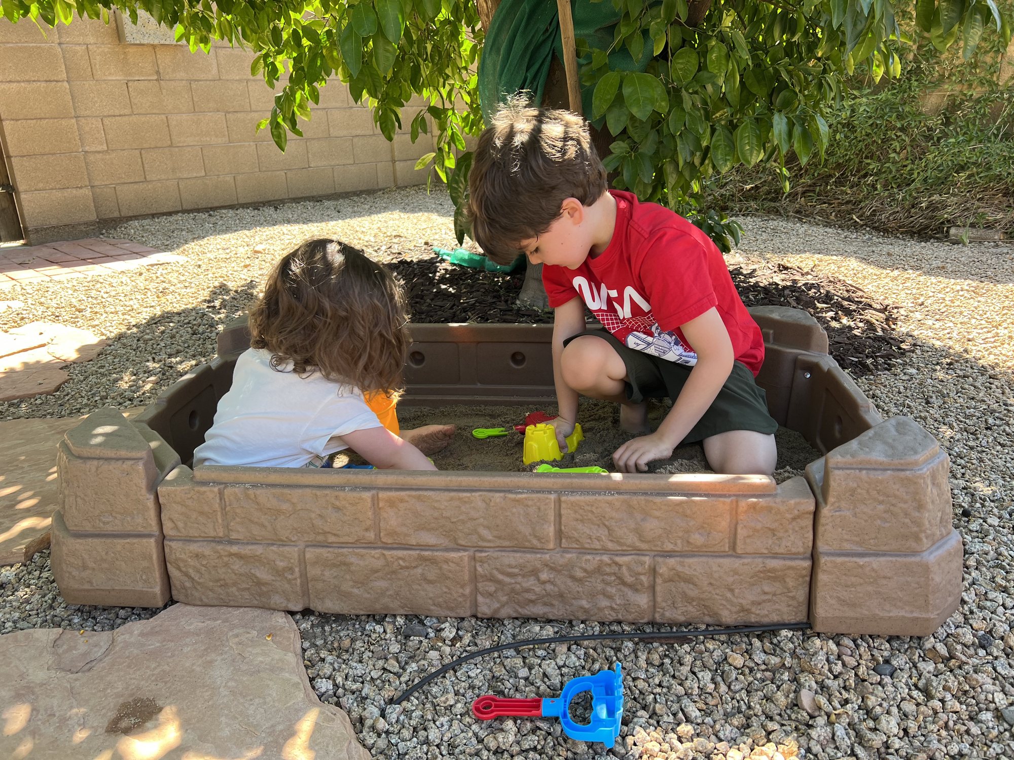 Enjoying their new sandbox from Grandma TT and Grandpa Stan!