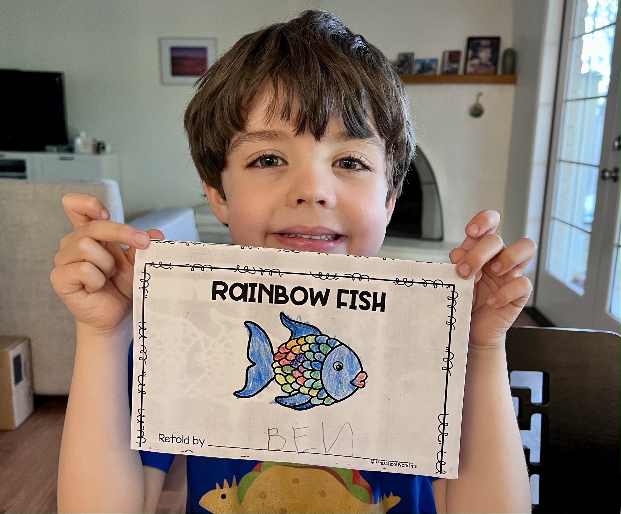 Showing off his rainbow fish from school