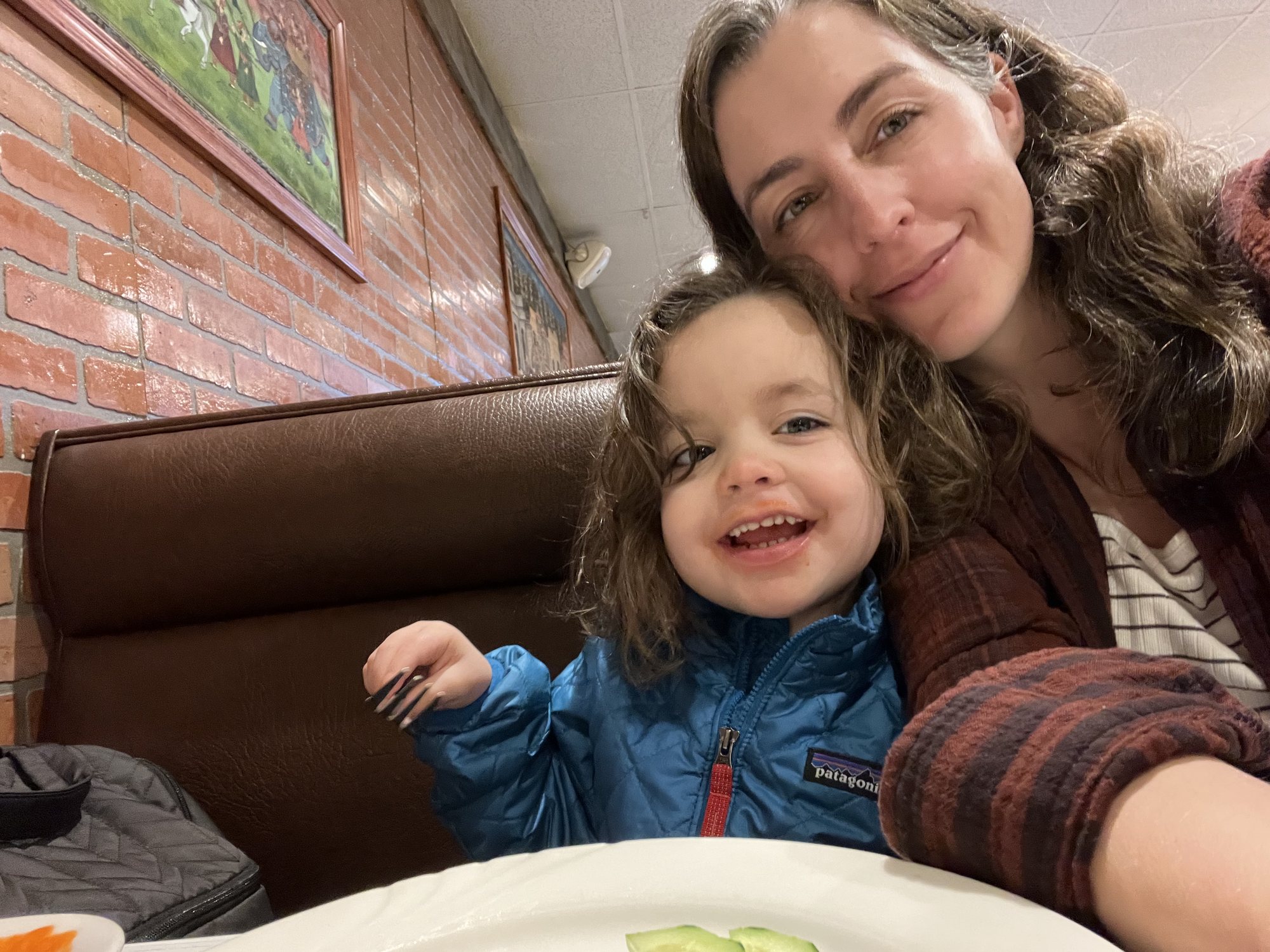 Nora trying Indian food at a restaurant for the first time.