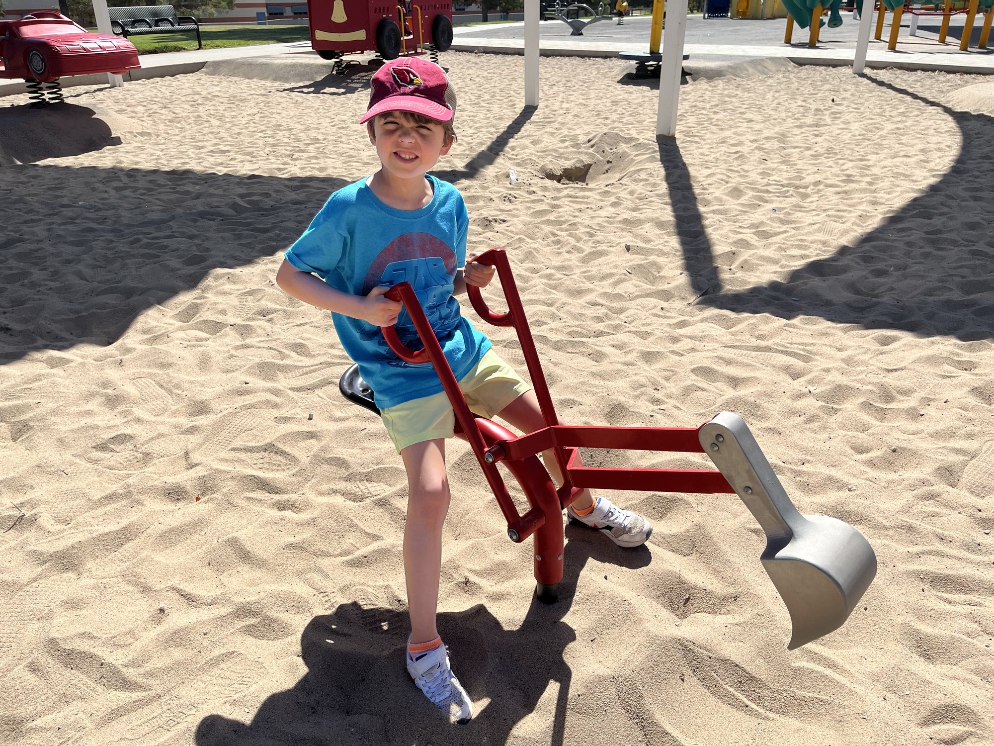Playing with a digger at the park.